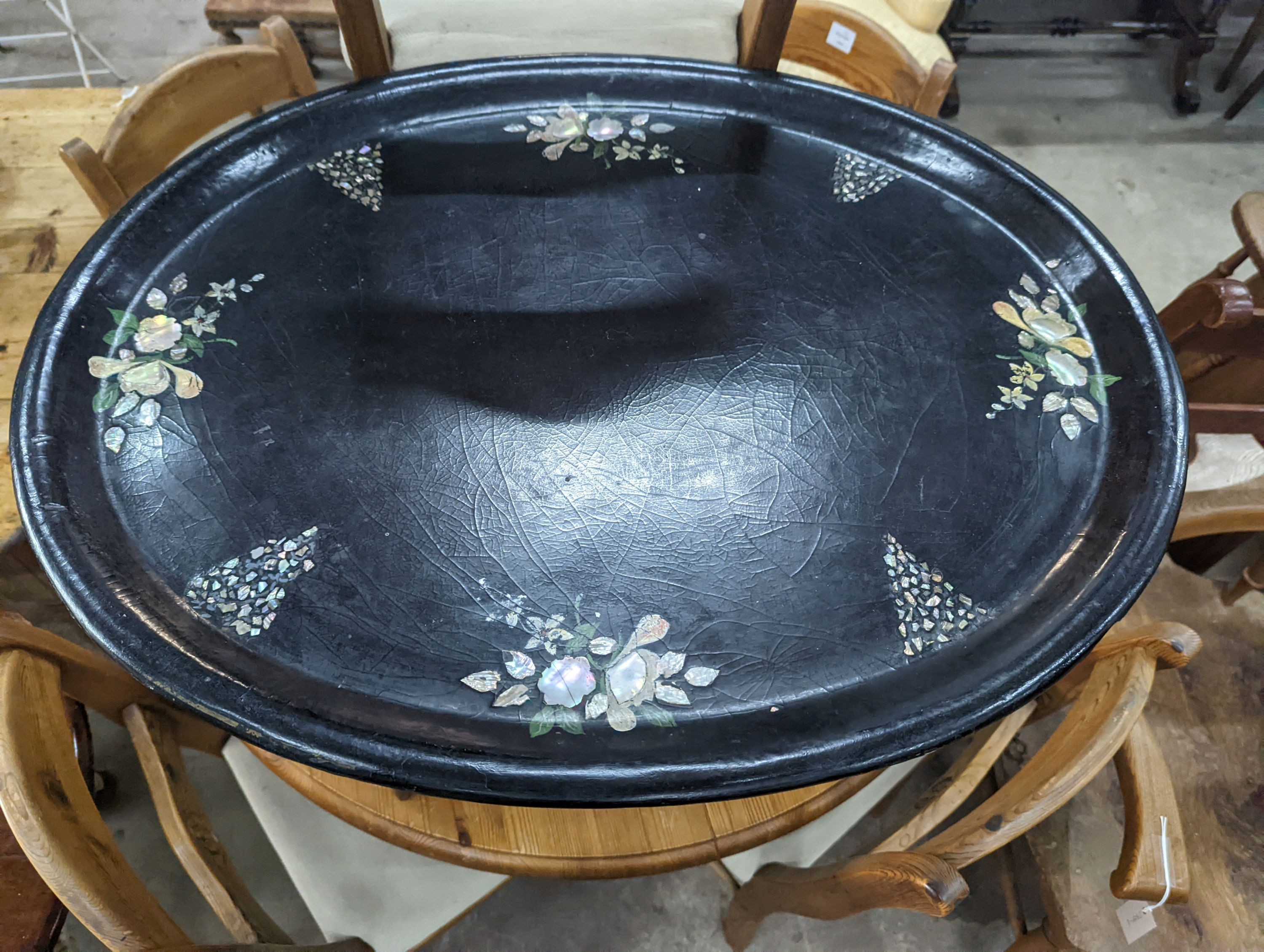 A Victorian oval floral painted papier-mâché tray, on faux bamboo frame, width 75cm, depth 61cm, height 49cm